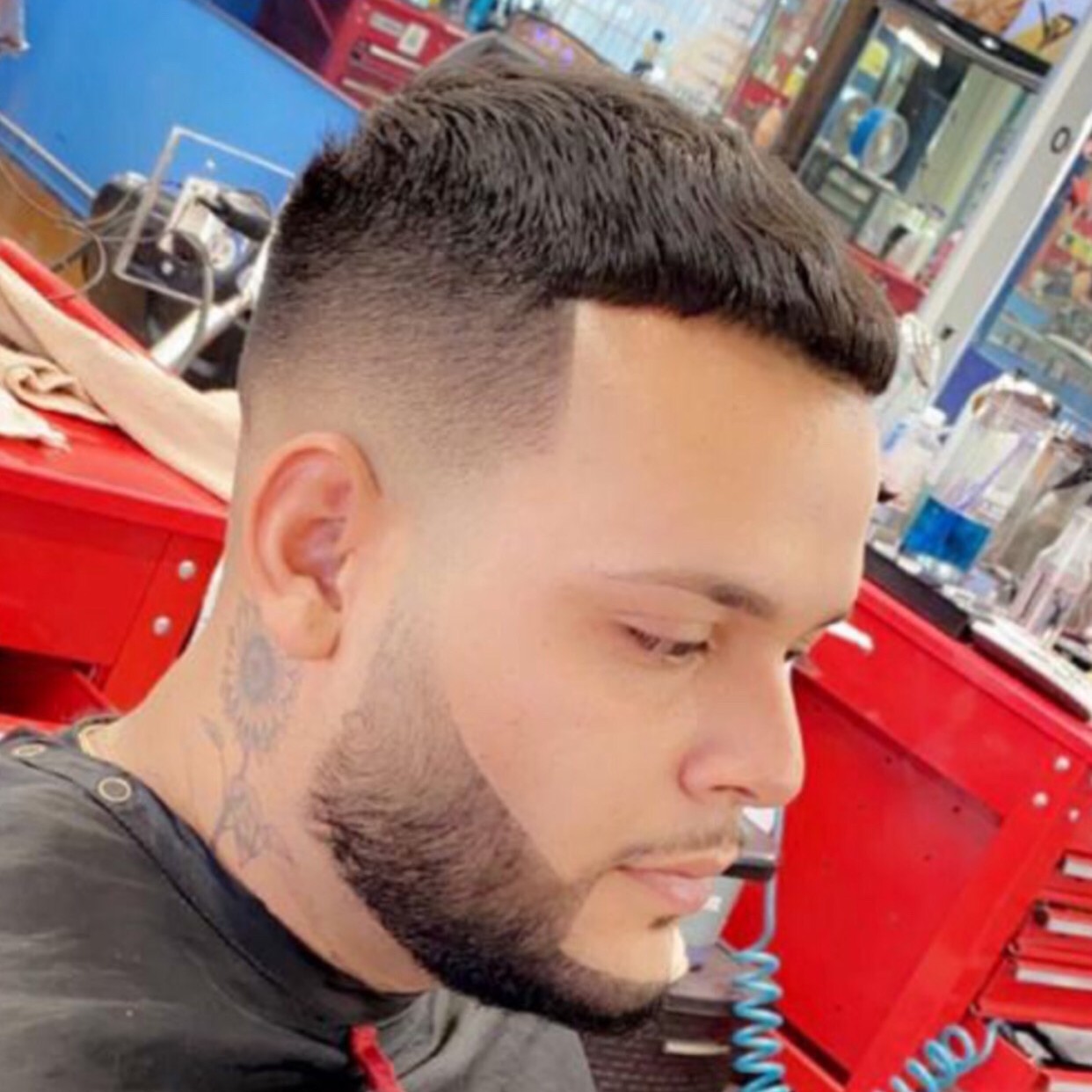 Man with clean fade haircut and beard lineup